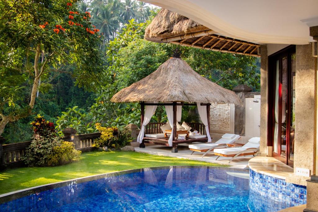 Victory Bali offers a luxurious experience at one of the best hotels Ubud with private pools. Seen here is a pavilion in the background, two pool beds, and the crystal clear water of the private pool. 